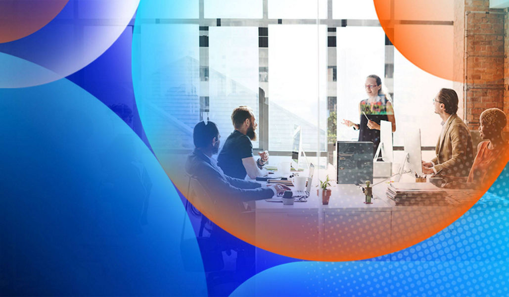 A team of people sitting at their desks in an office with a window in background along with an orange and blue lens overlay