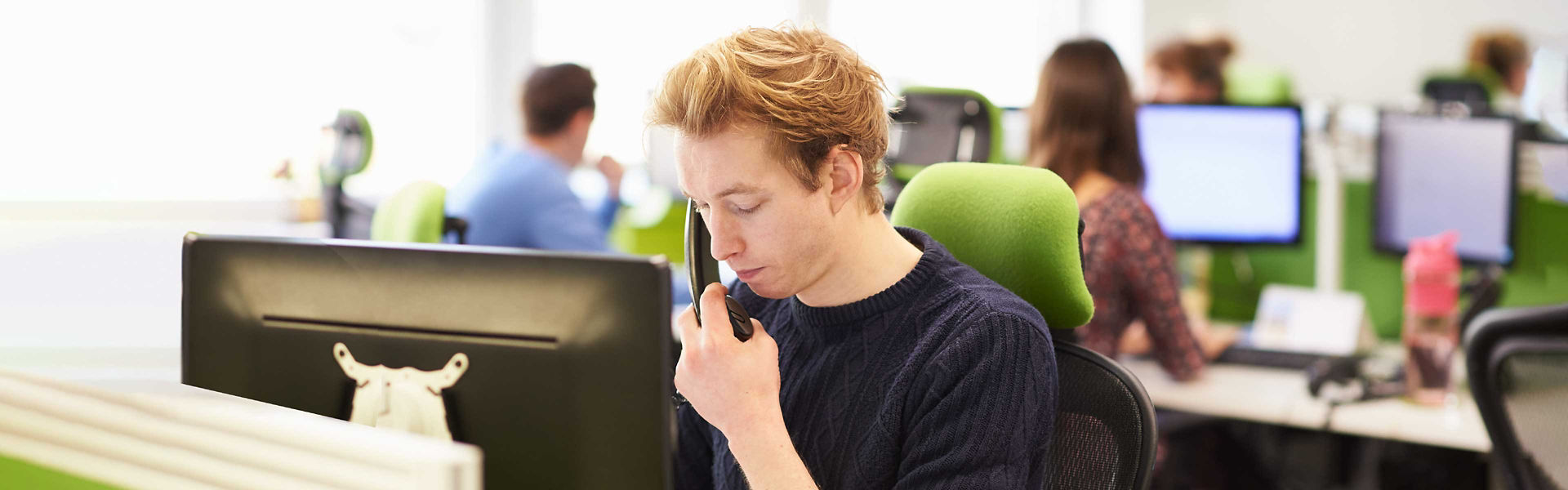 A call centre operator taking a call in a call centre