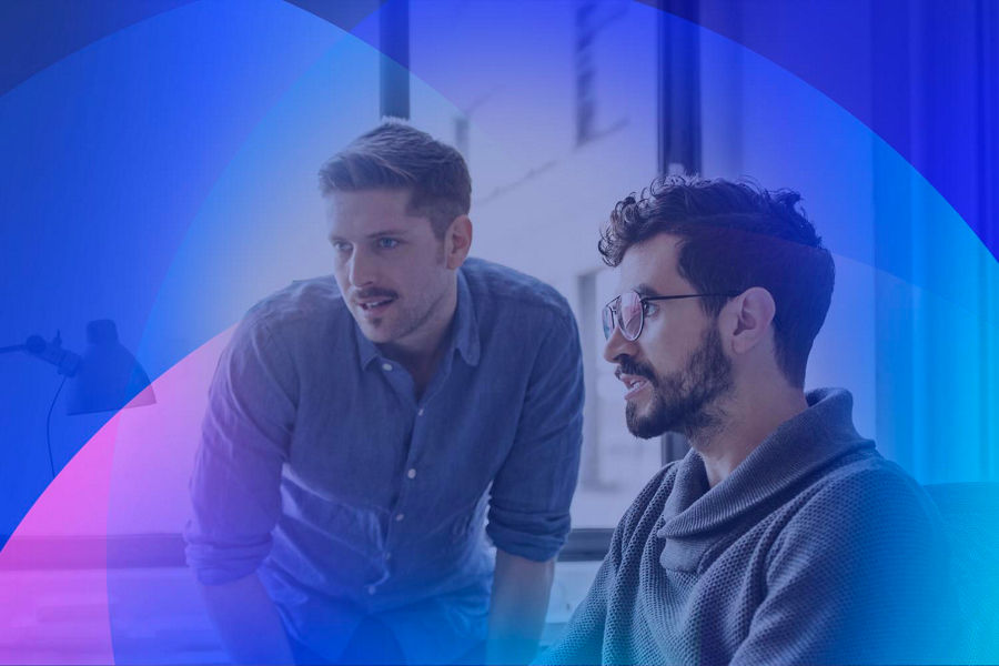 Two business professionals working together on a computer.