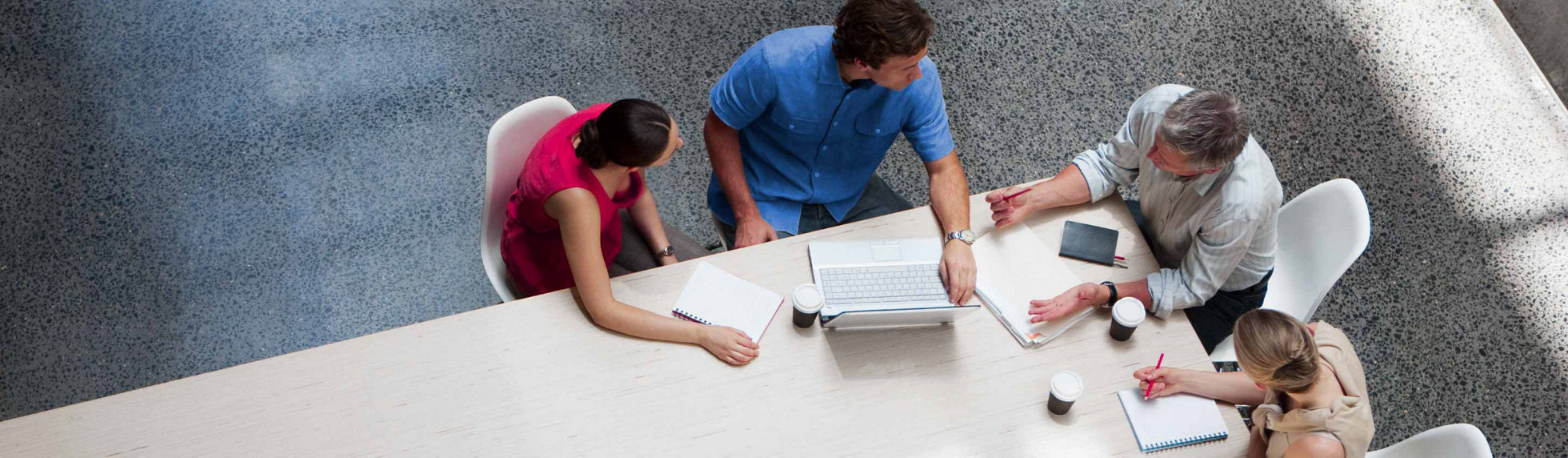 A group of people having a business discussion at an office table