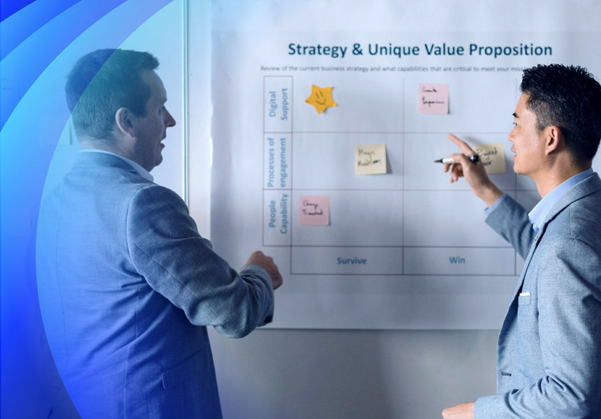 Two businessmen discussing sticky notes on a whiteboard
