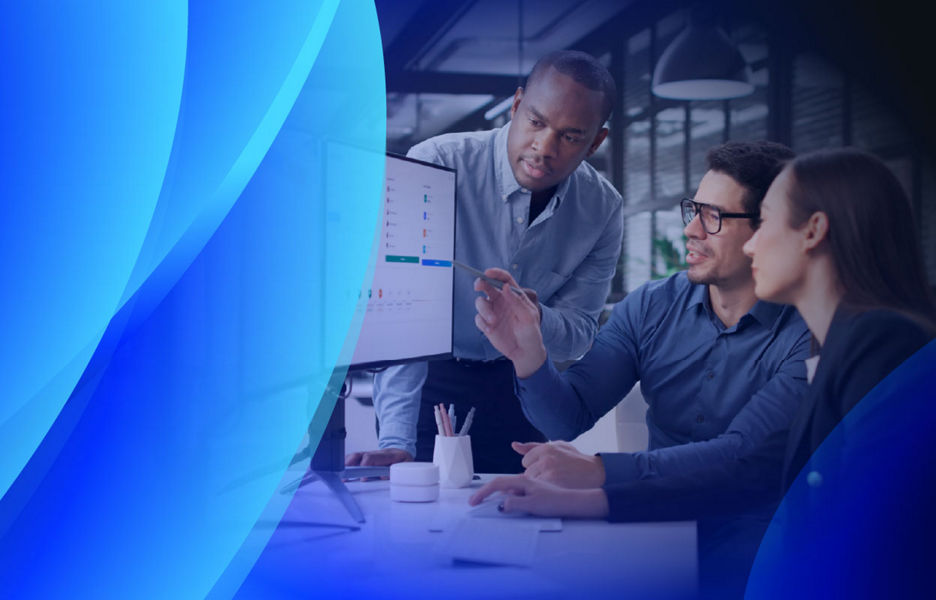 A small team reviewing their company’s software records on multiple screens