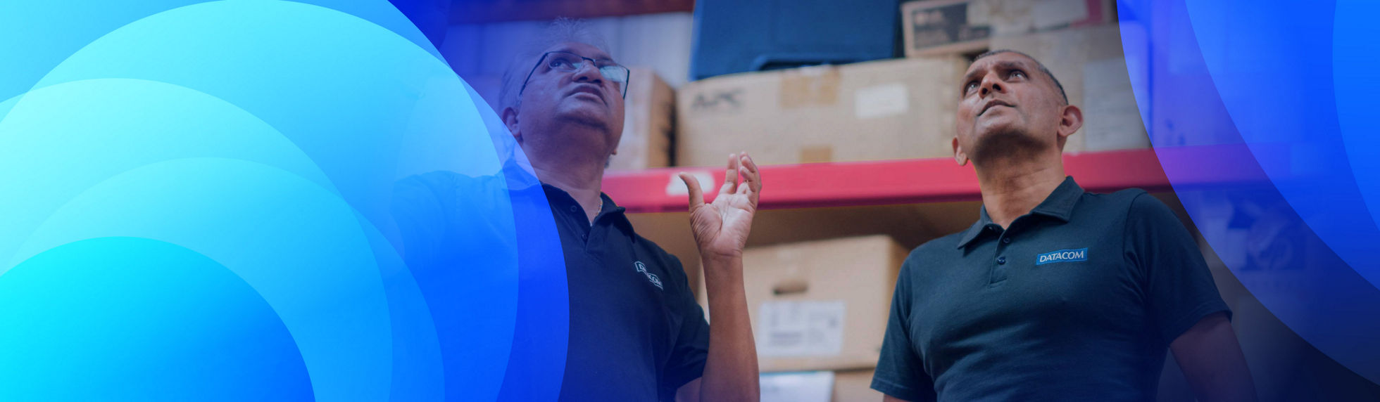 Two Datacom warehouse working having a discussion about stock