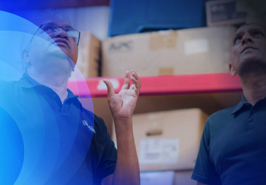 Two Datacom warehouse working having a discussion about stock