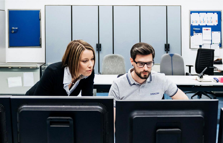 Man and woman looking at a computer screen