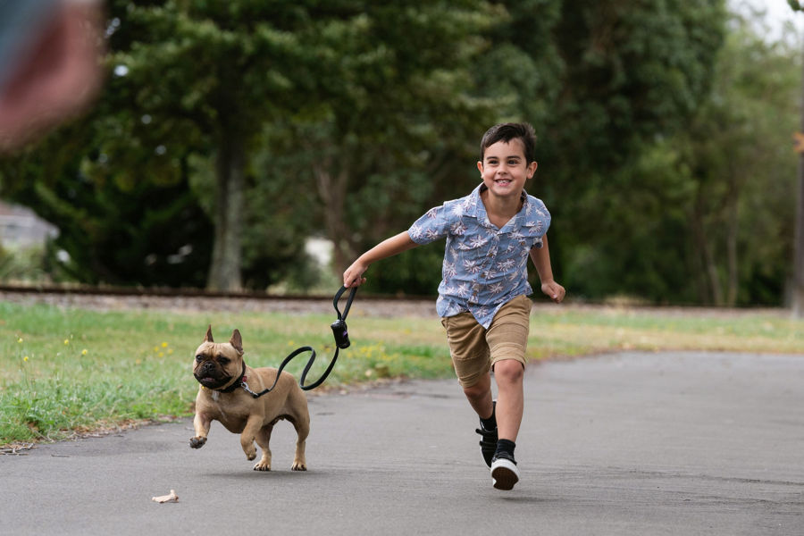 boy running with his dog