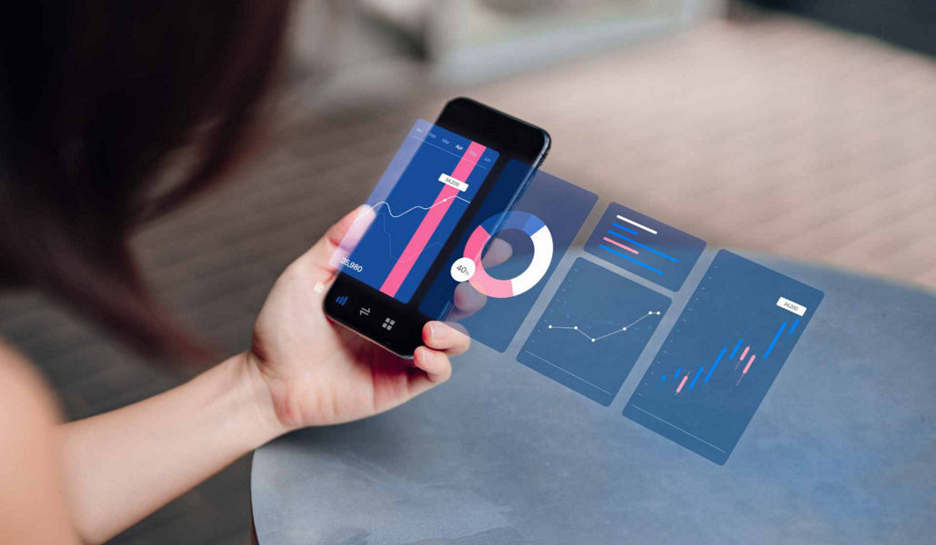 A woman holding a phone with analytics displayed