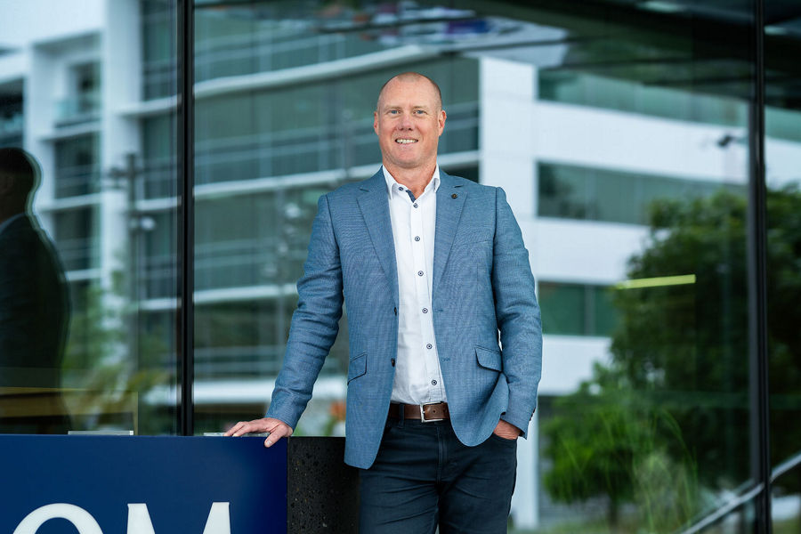 Photo of Datacom’s Mike Walls standing next to the Datacom building in Auckland