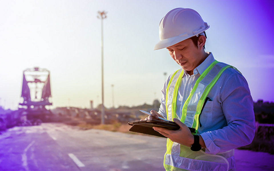 A person wearing a hard hat running field tests