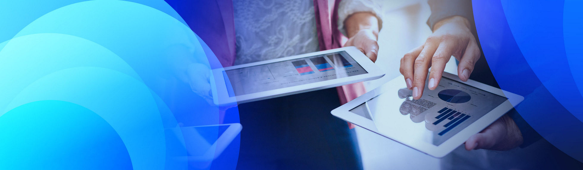 Two people reviewing analytics on tablets