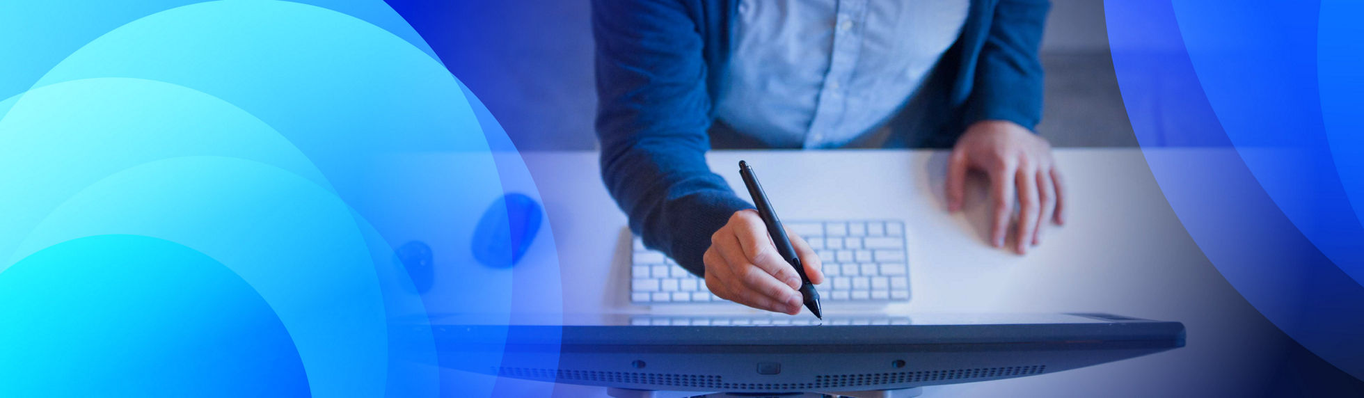 A person in a suit using s stylus to write on a monitor