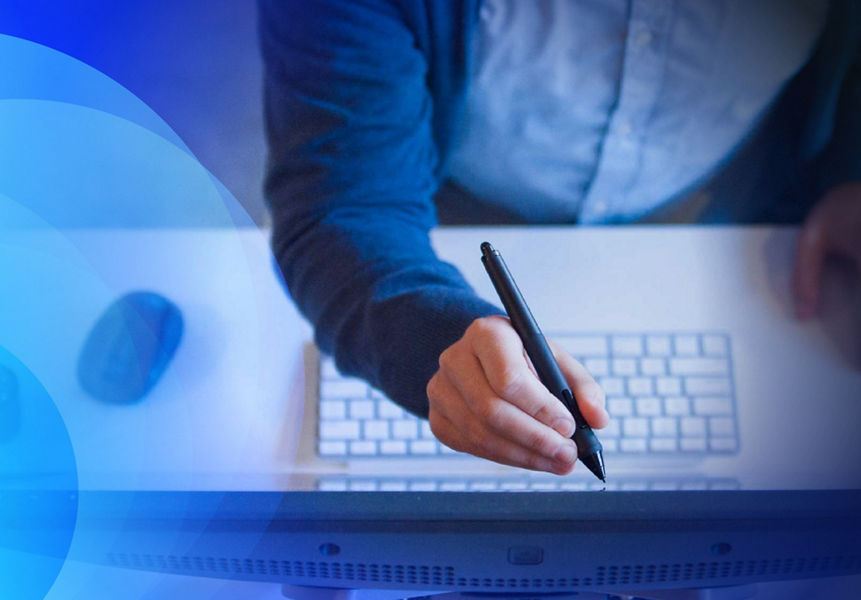 A person in a suit using s stylus to write on a monitor