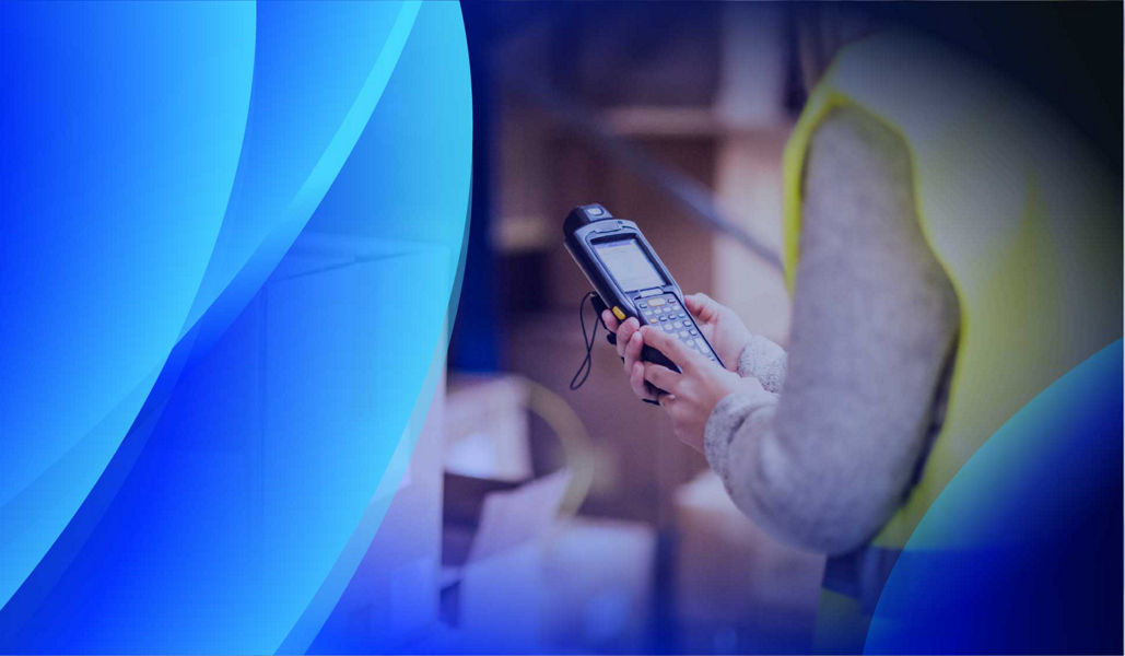 A warehouse worker scanning tagged assets