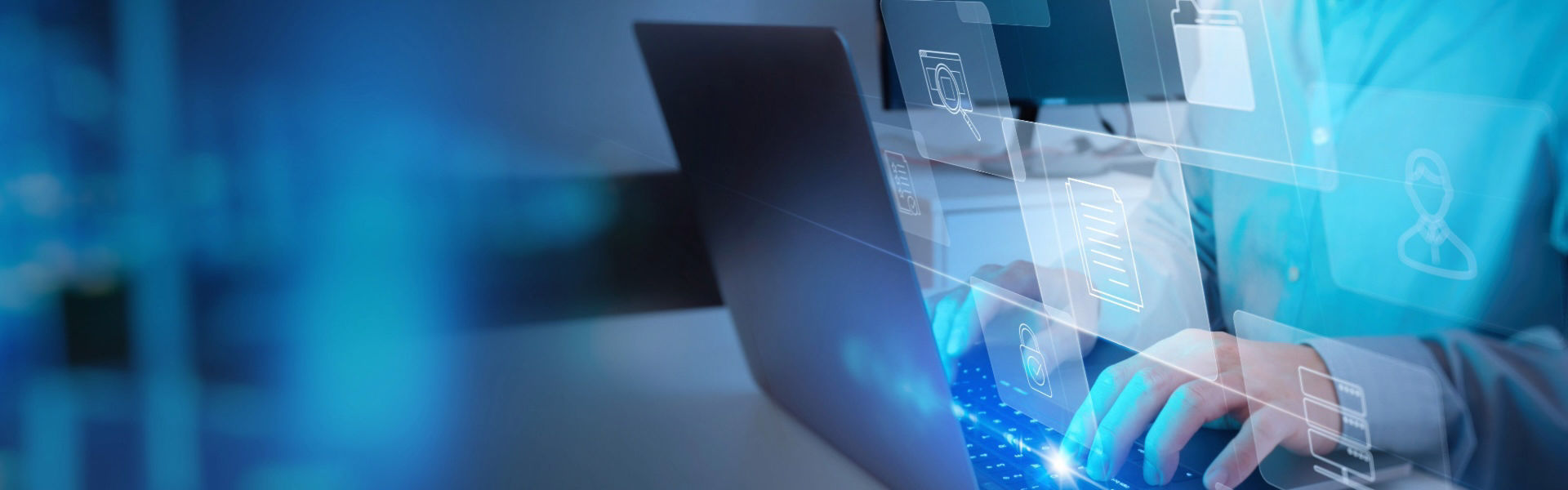 Male hands typing on laptop with blue software imagery