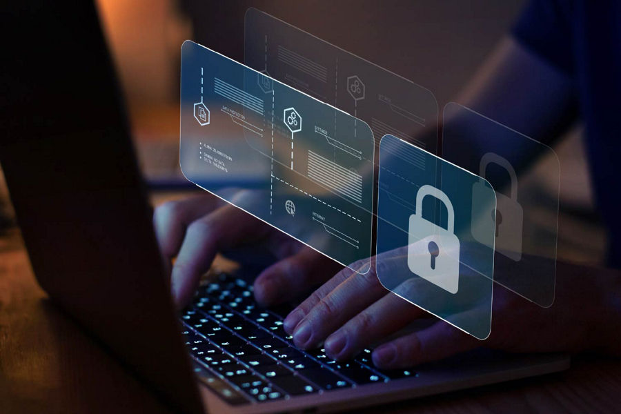 Person typing on a laptop with virtual data security icons overlayed