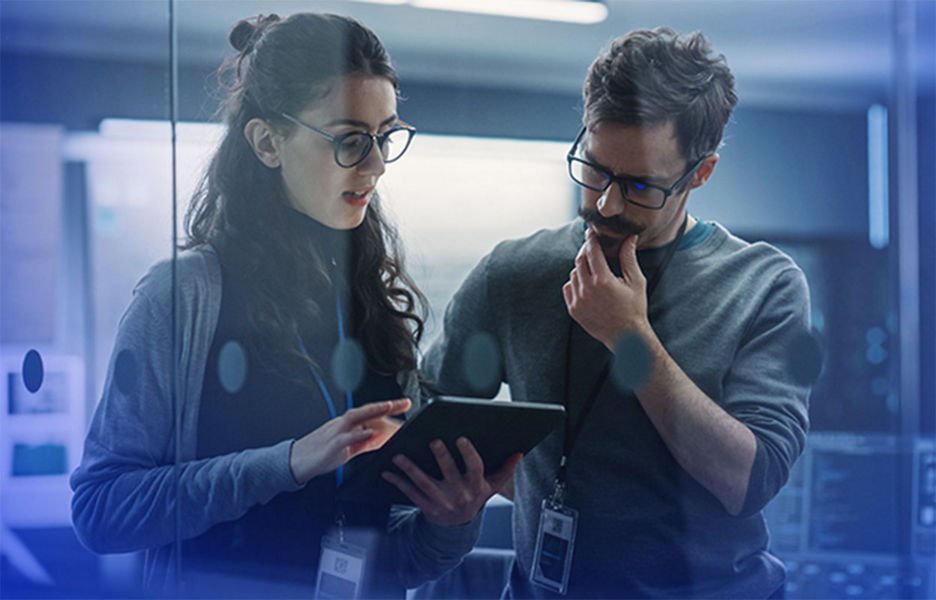 Two colleagues collaborating while looking at a tablet