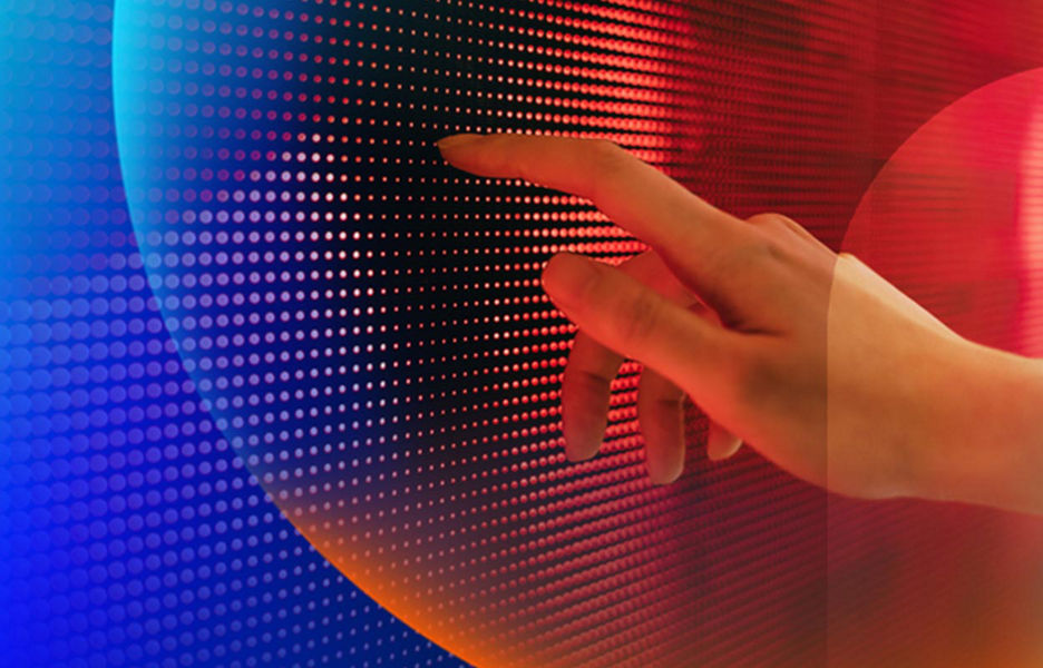 A persons hand touching an LED tech wall