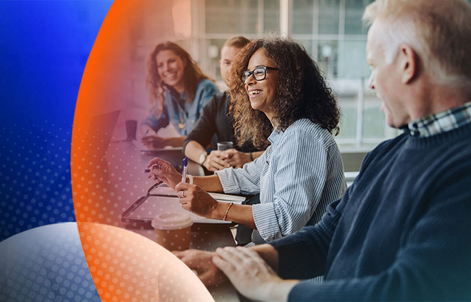 A group of people sitting down in a meeting room at a table discussing and writing notes with an orange and blue lens overlay