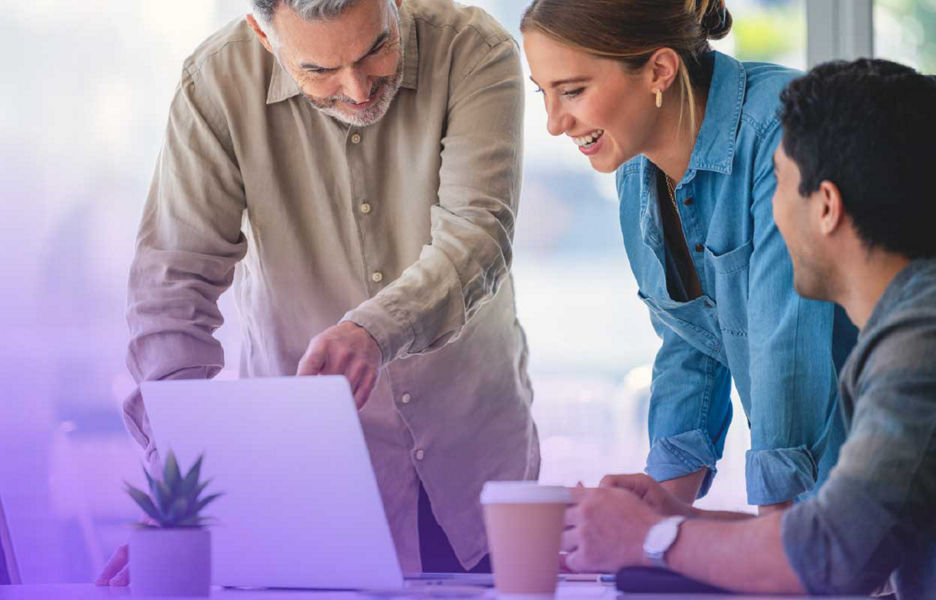 A group of people looking at a laptop screen together
