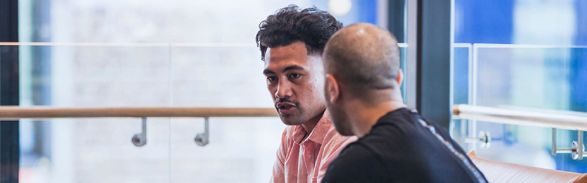 Two people having a discussion in an office environment