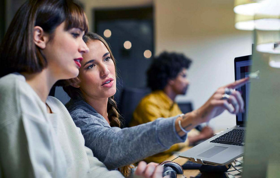 Officeworkers pointing at a screen