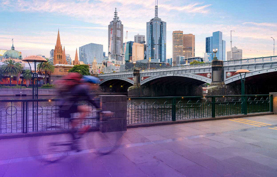 Man on biking with a background of city central