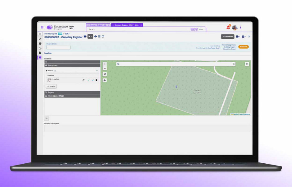 Laptop showing the Datascape enterprise demo website cemetery register panel 