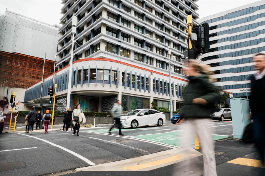 Wellingtonians walking outside of RBNZ's building