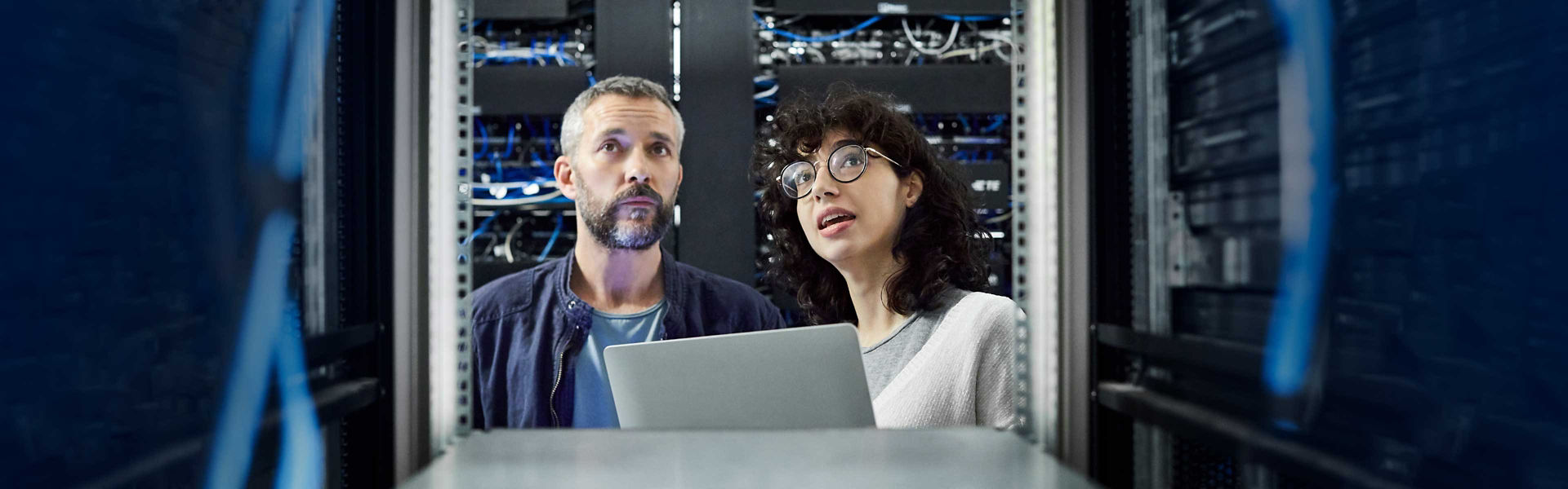 A man and a woman discussing rack space sizing in a data centre