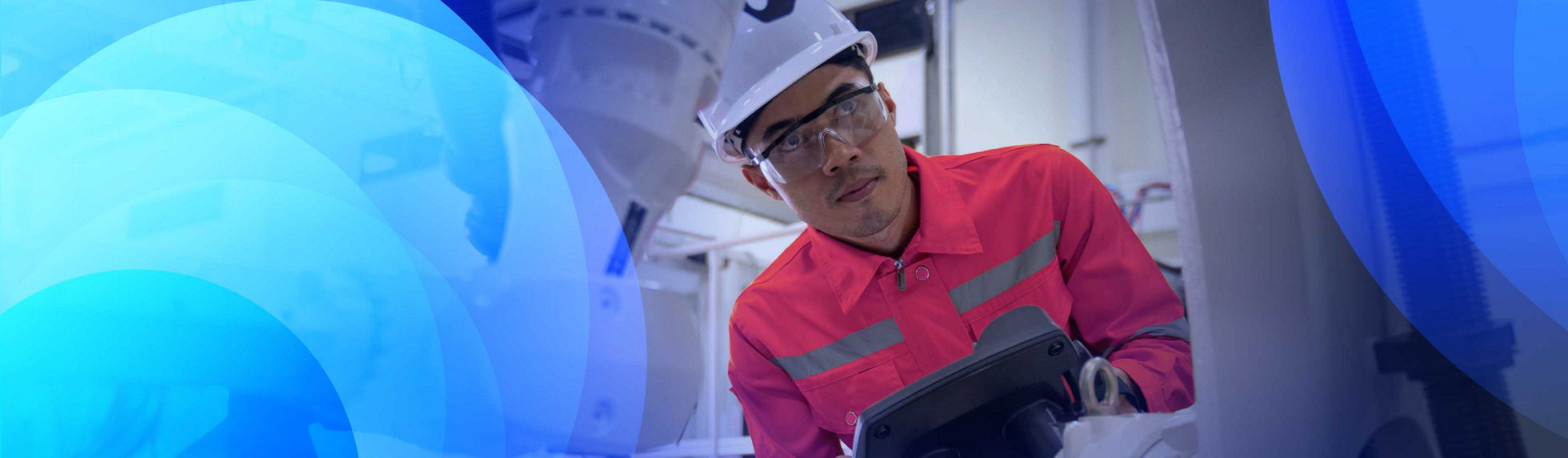 A robotics technician running tests on a machine