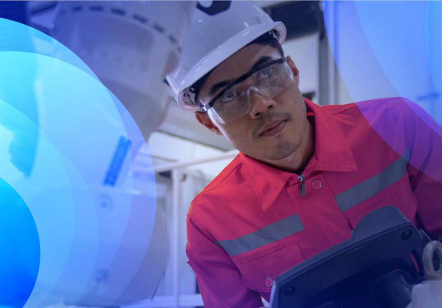 A robotics engineer running checks on machinery