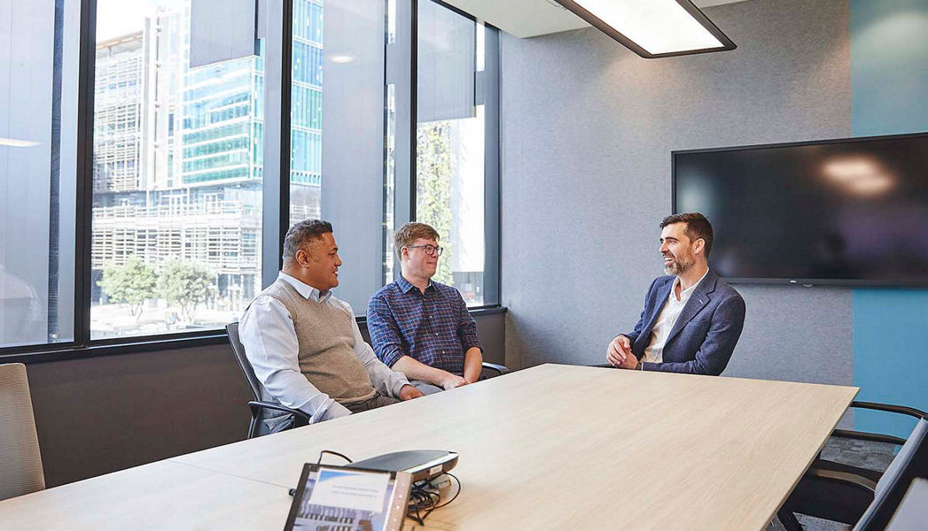 Russell Page-Wood having a discussion with clients at Datacom's Auckland office