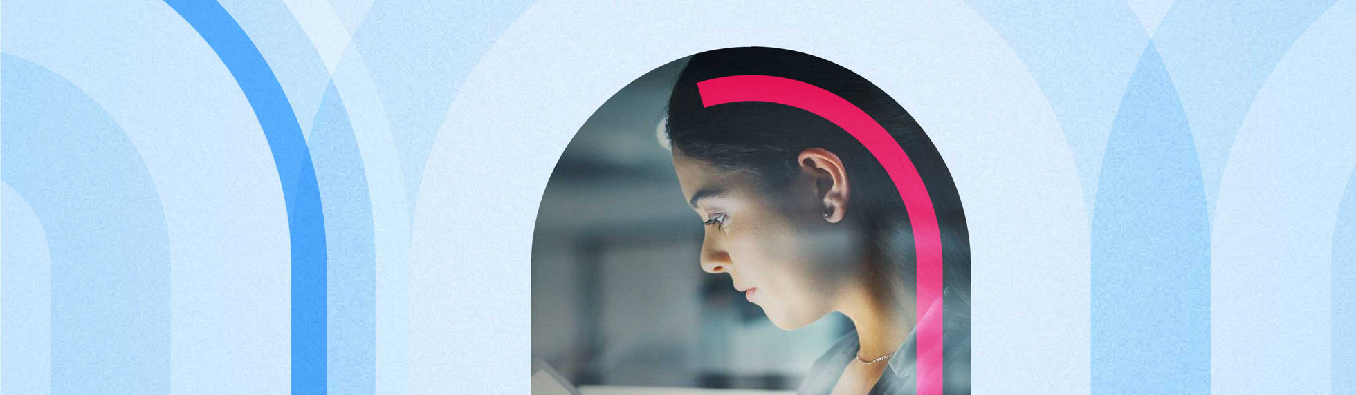 Light from the screen of a tablet illuminating the face of a young businesswoman