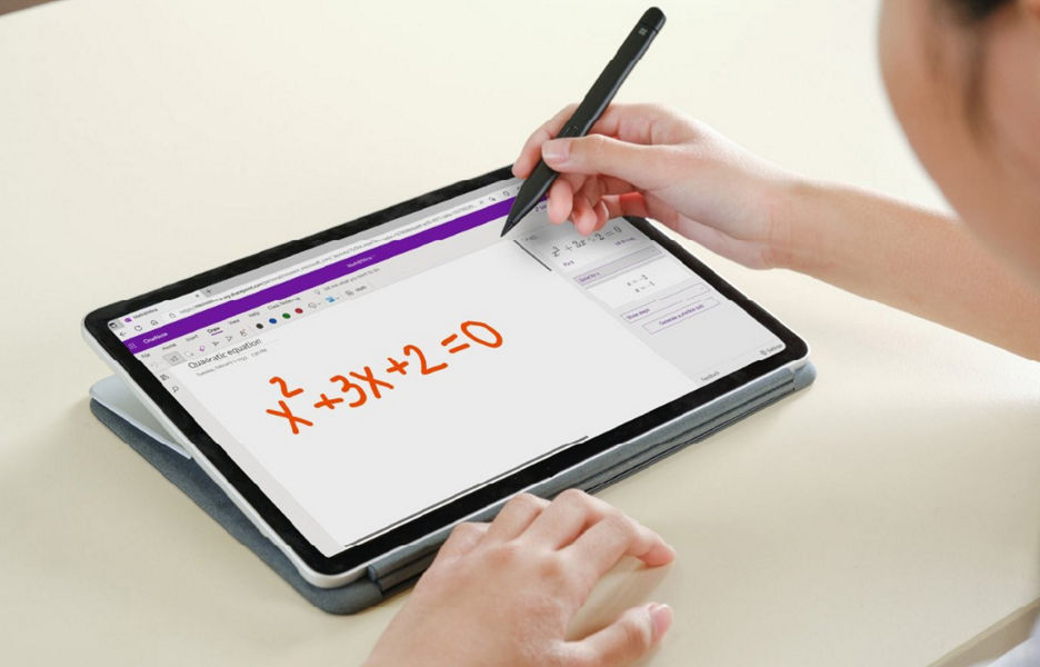 Close up of person writing a maths equation on a device