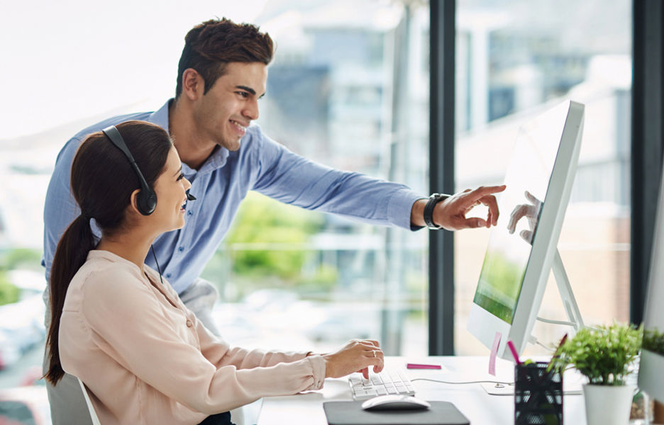 A woman and a man discussing in a office setting