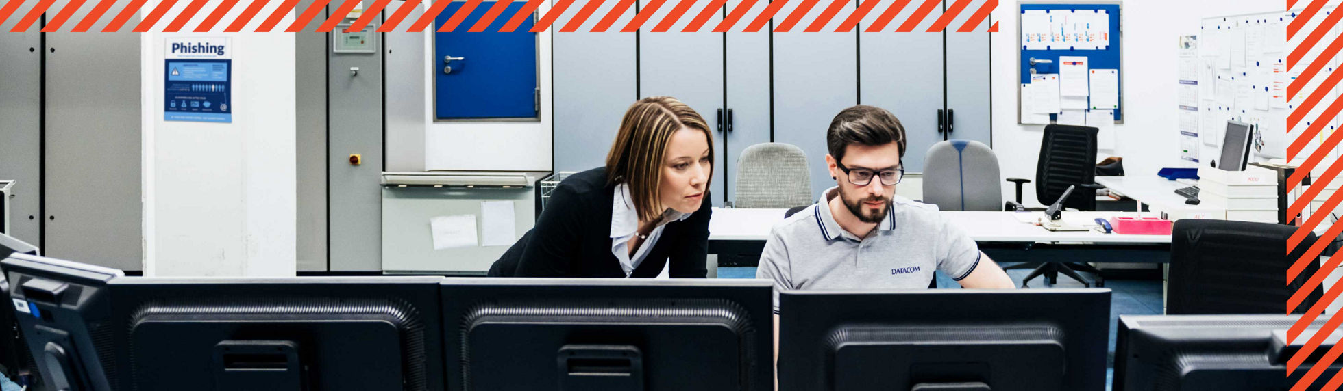 Two security specialists monitoring a screen