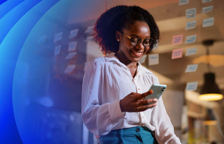Woman smiling looking at a smartphone