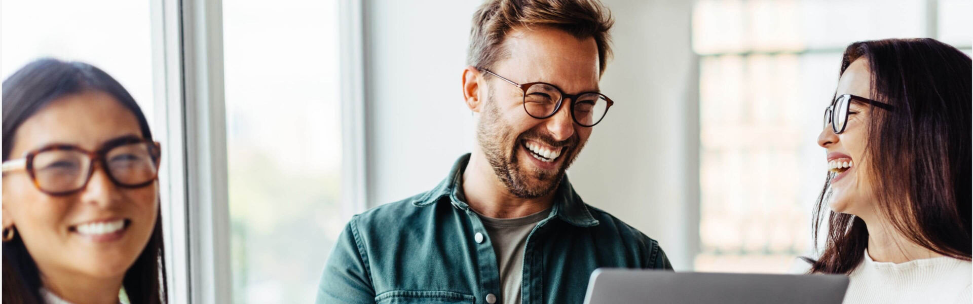 Happy team happy in a meeting together with a laptop