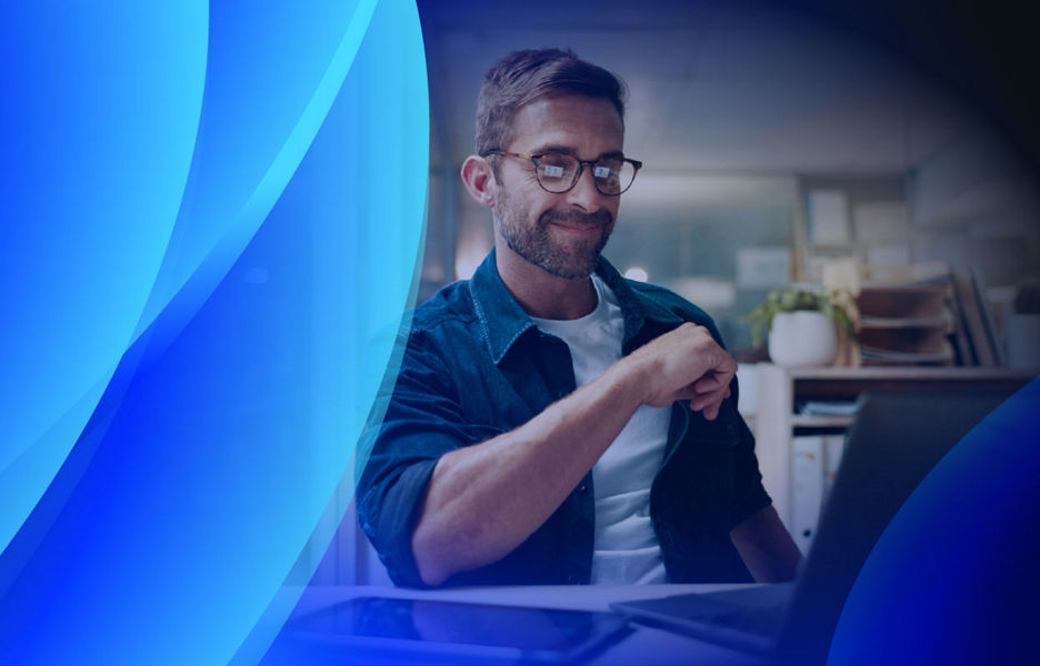 A man looking at his company's software on a laptop