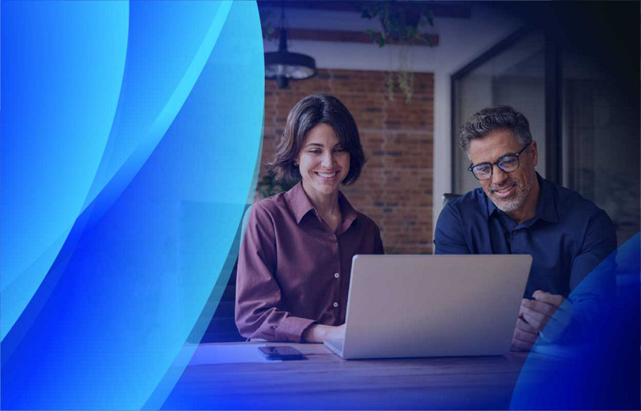 Woman and man looking at a computer with Datacom brand overlay