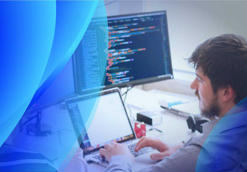 Man in front of computer screen reading code