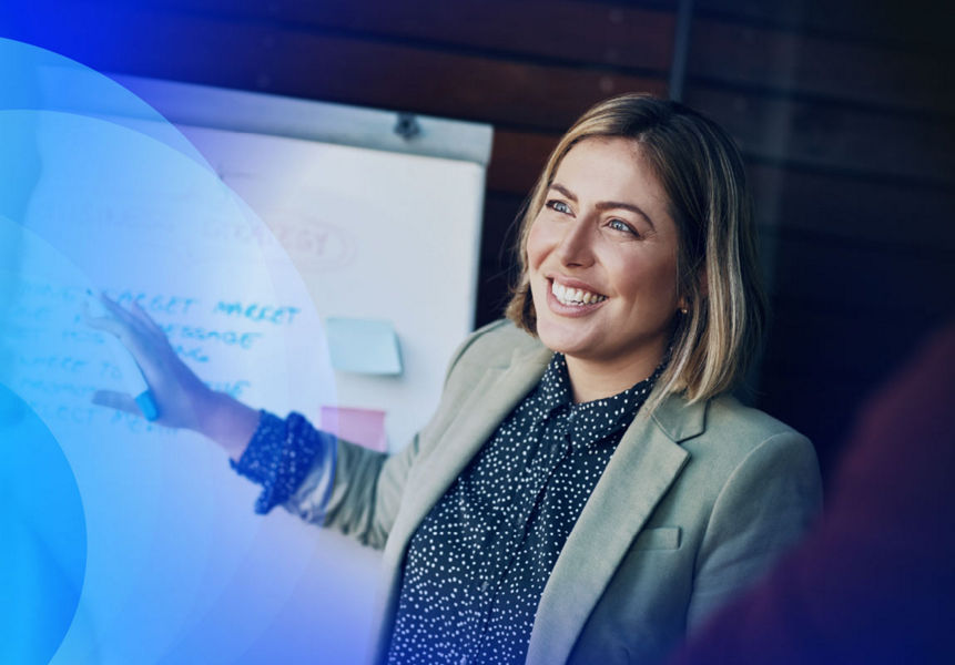 A smiling female professional presenting technology strategy. 