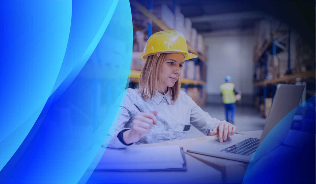 A woman in a warehouse assessing supply chain processes