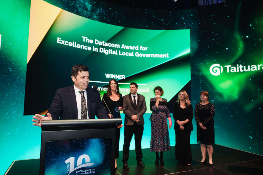 Datacom employees on stage accepting the role of exclusive technology partner for the Taituarā Principal Partners programme