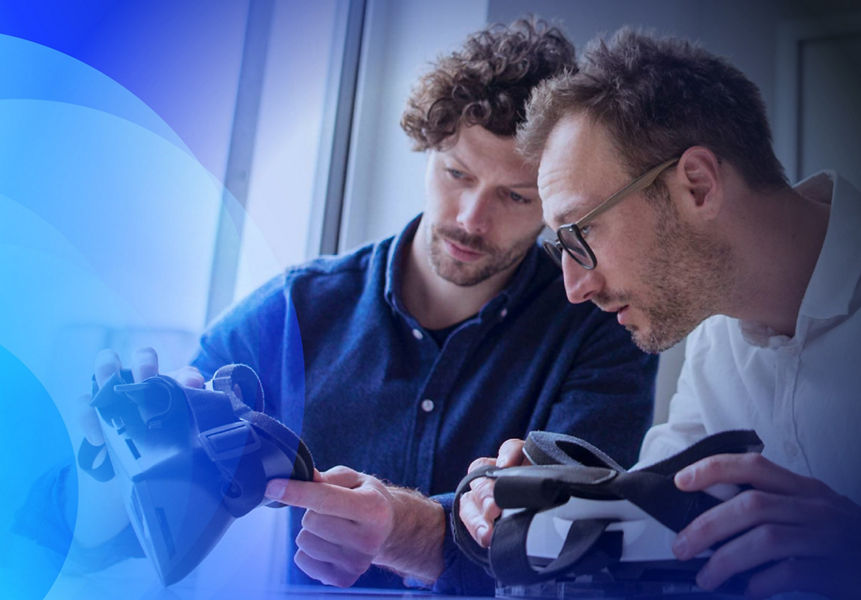 Two technology experts reviewing a VR headset