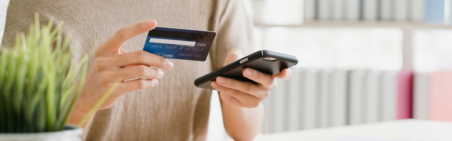 Woman using her banking app at home to make a transfer