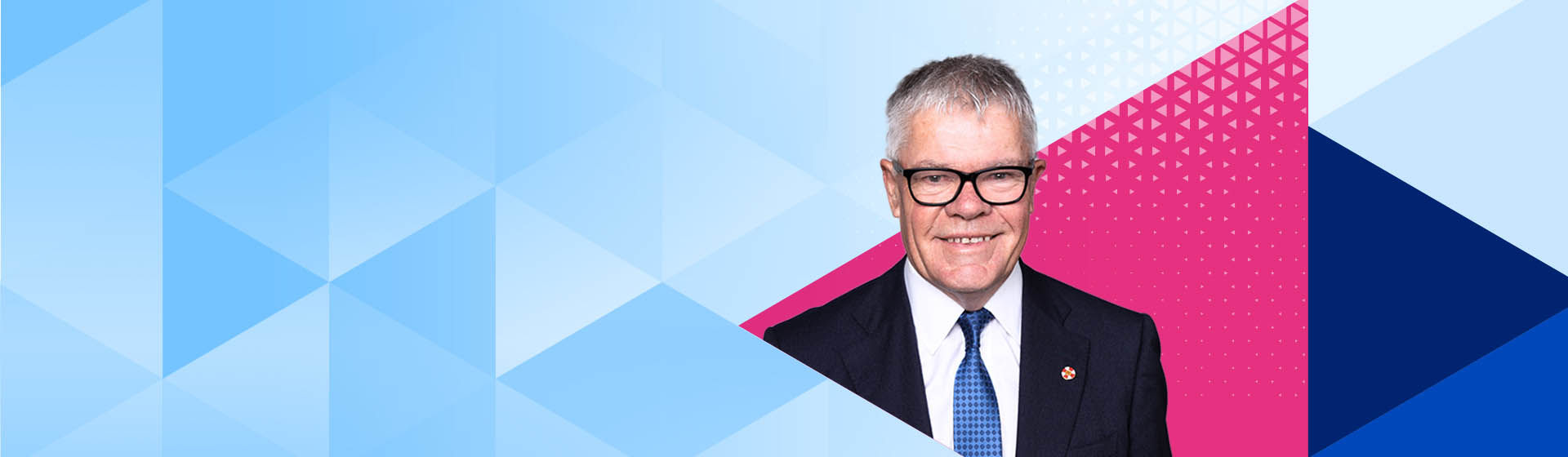 Datacom Group Chair Tony Carter surrounded by a Datacom diamond shapes