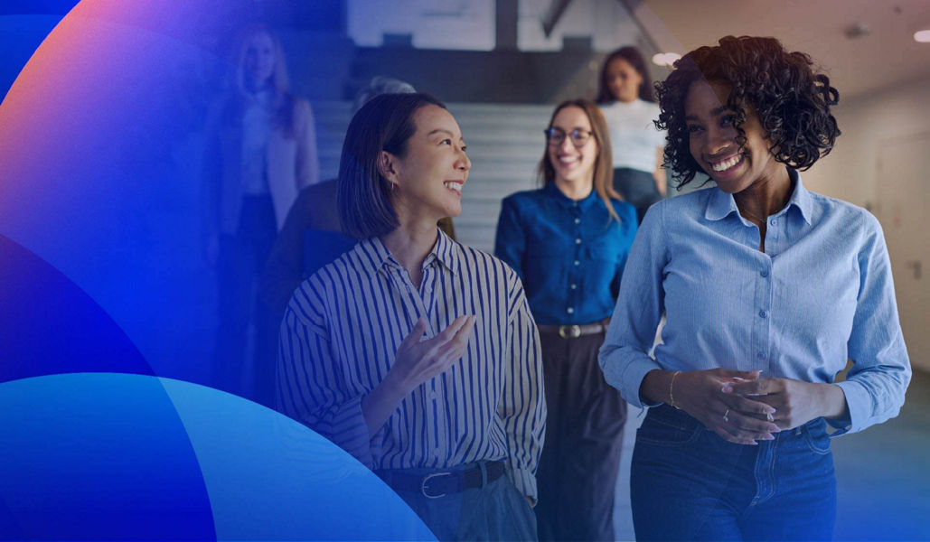 A diverse team walking and talking in office hallway 