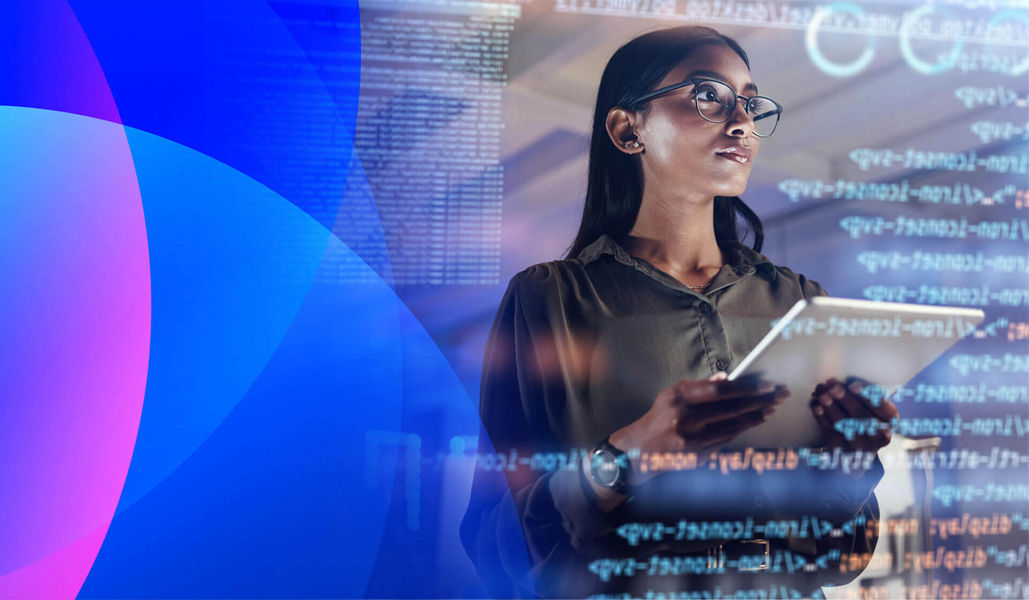 A woman standing in front of a digital screen analysing information