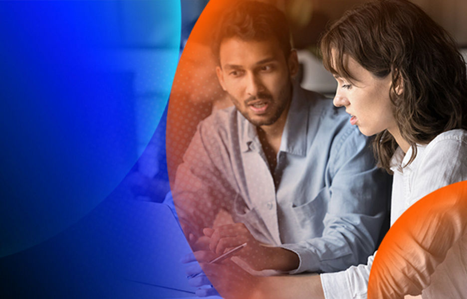 Two people having a conversation while looking at a laptop on their desk with an orange and blue lens overlay
